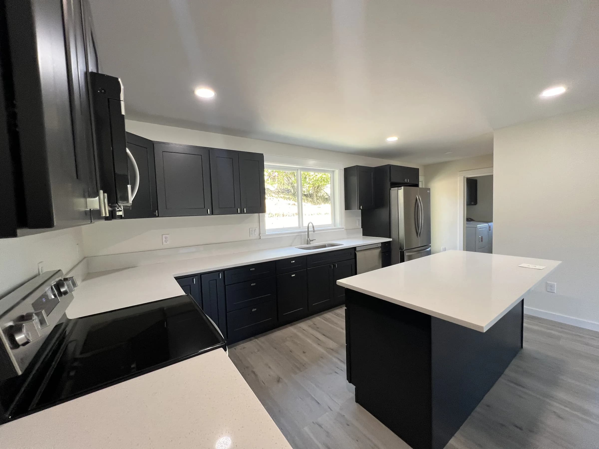 Open kitchen of the Hillside House with a quartz-topped island
