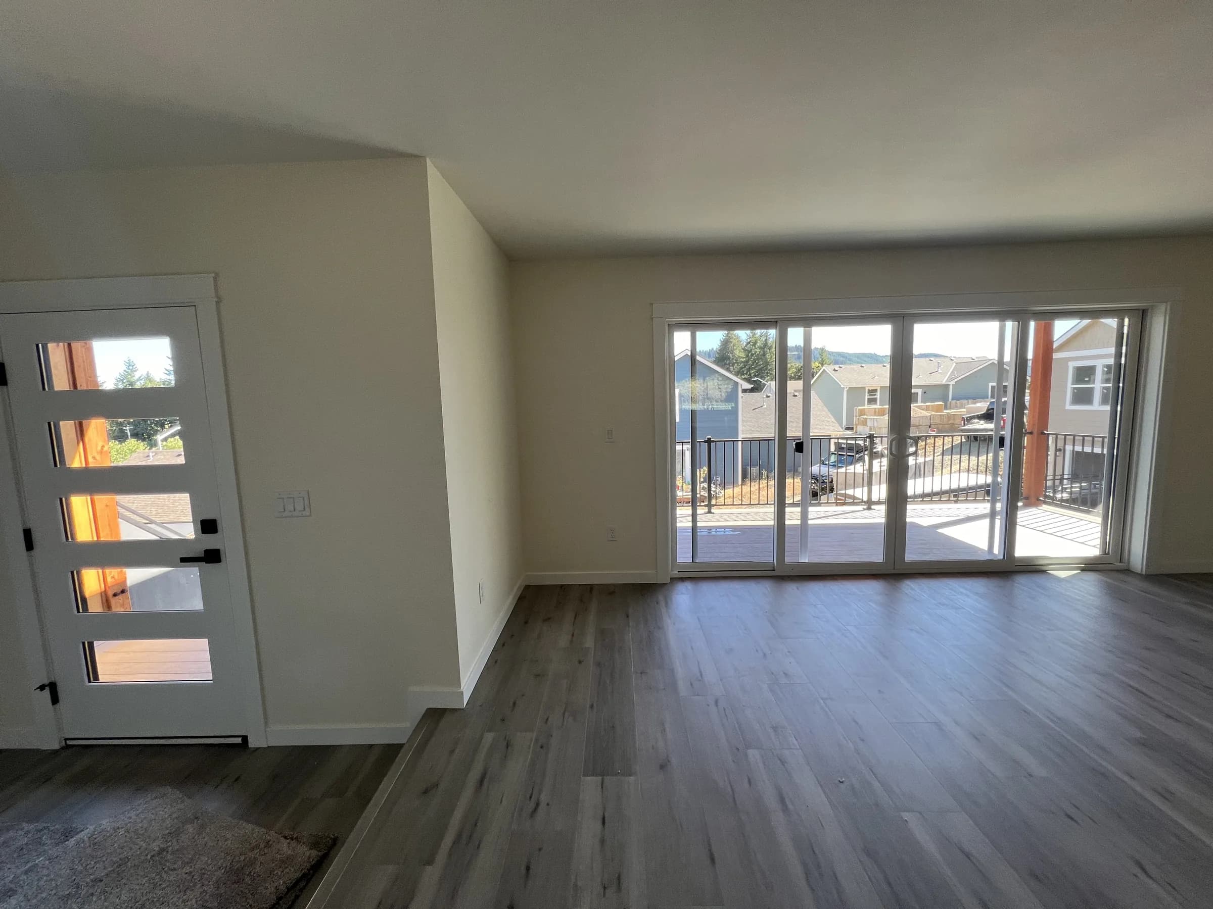 Living room of the Hillside House with sliding doors to a covered deck