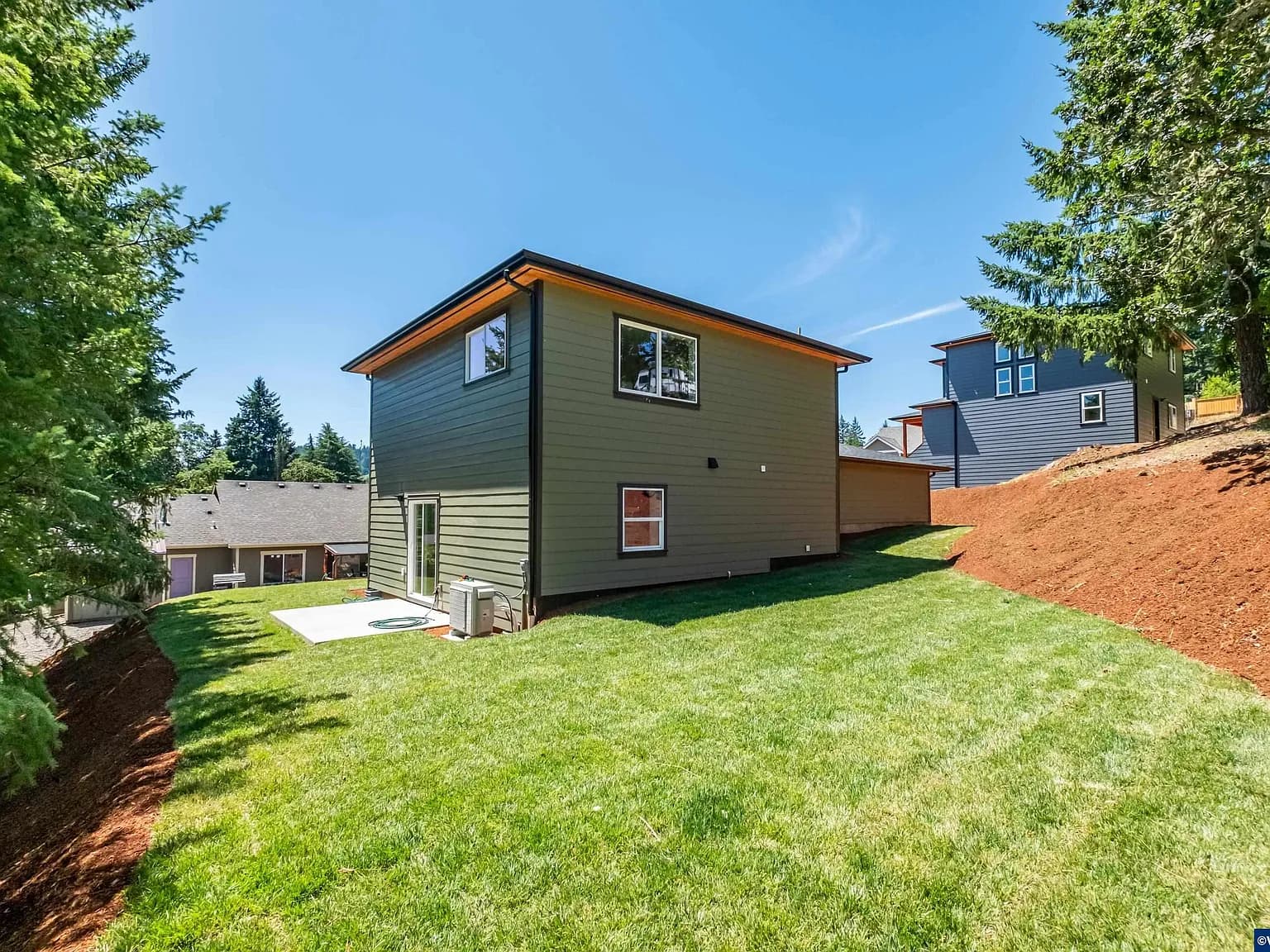 Rear elevation of the Sage House above a sloping back yard