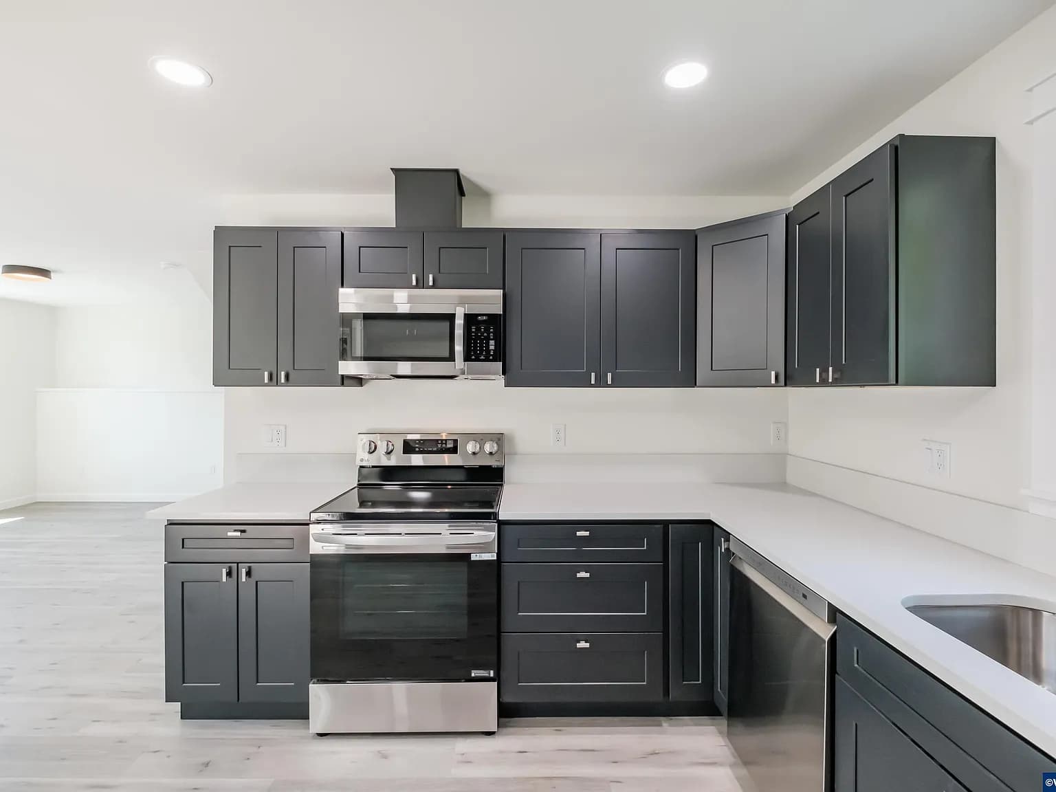 Kitchen of the Sage House with slate cabinetry and quartz counters