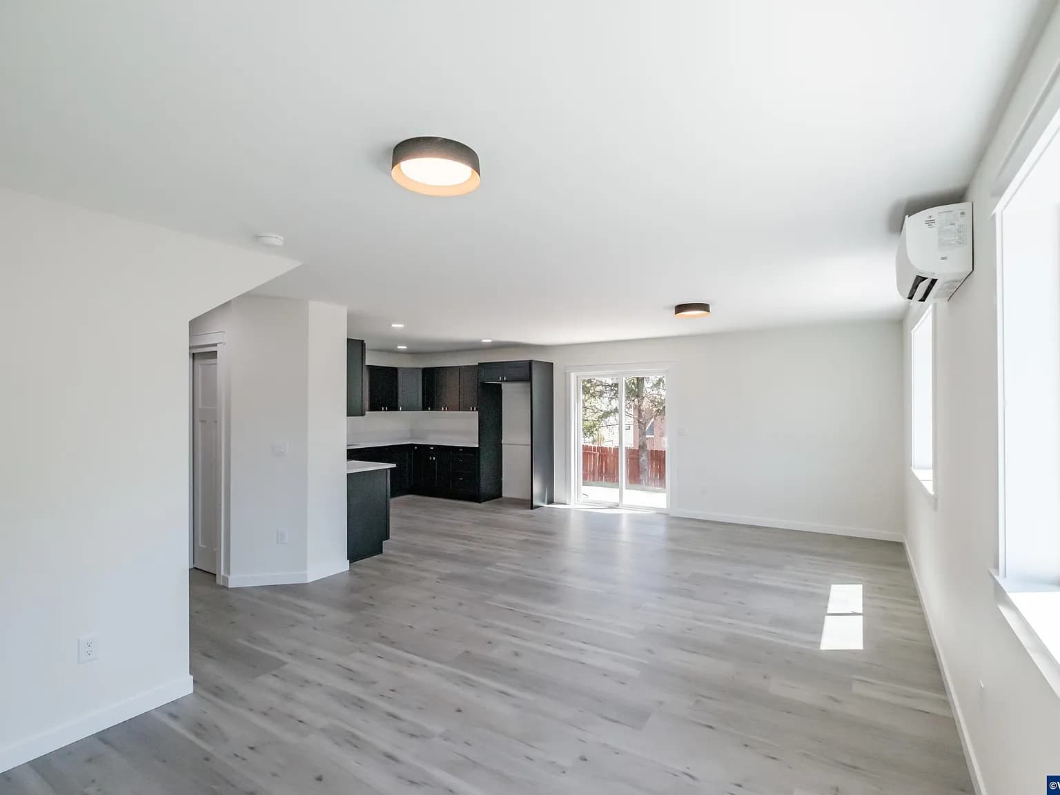 Open living and kitchen area of the Sage House with plank flooring